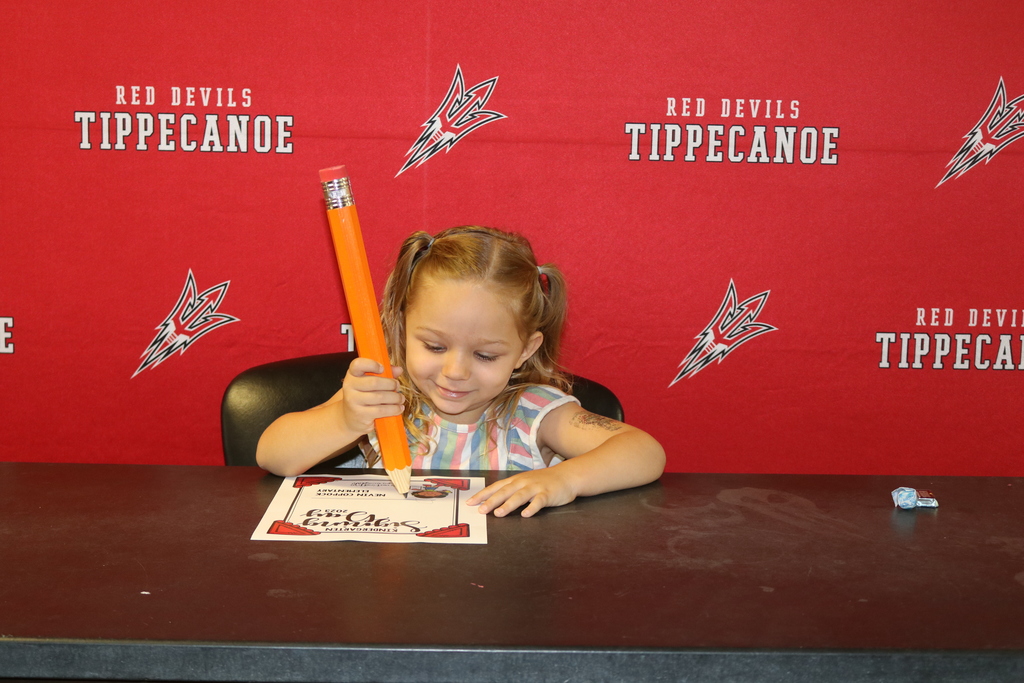Nevin Coppock student signing her commitment.