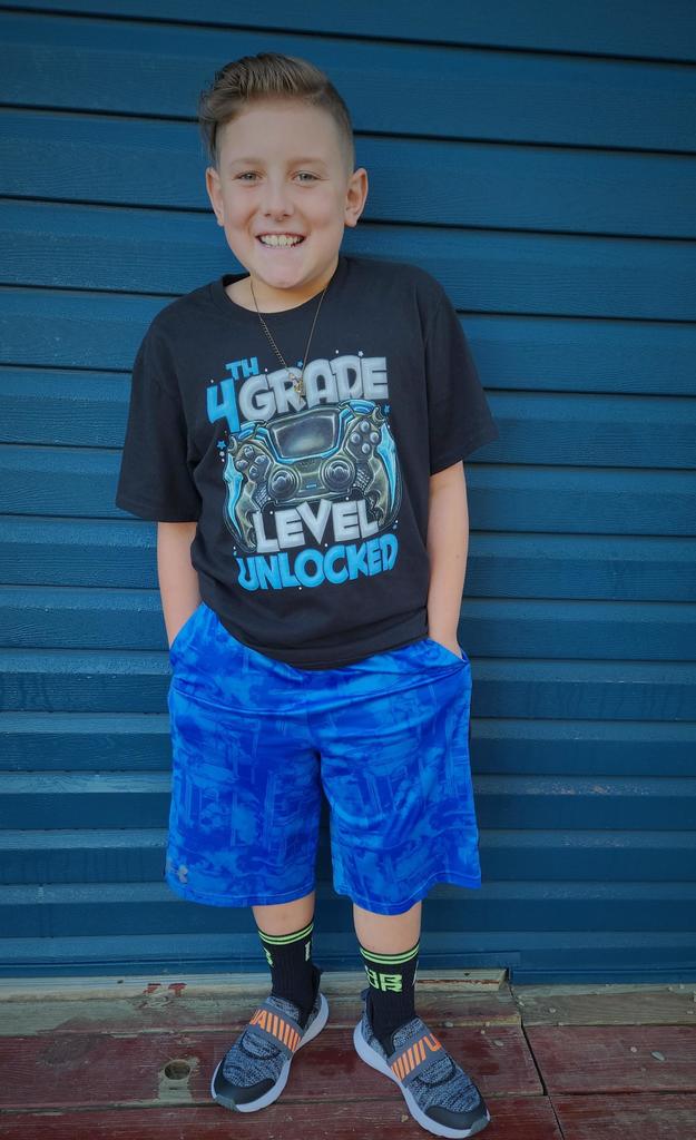 A young student poses for a first-day photo.