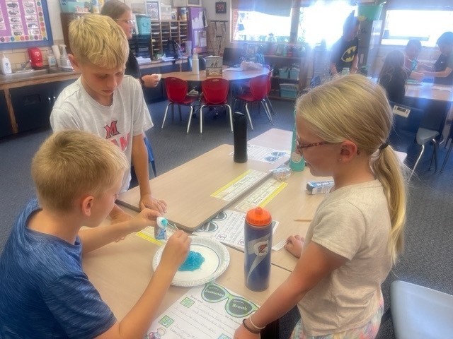 Taking the toothpaste out of the tube for a classroom activity. 