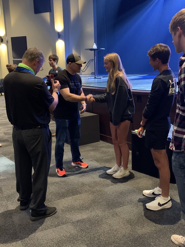 A THS student shakes hands with Kevin Hines.