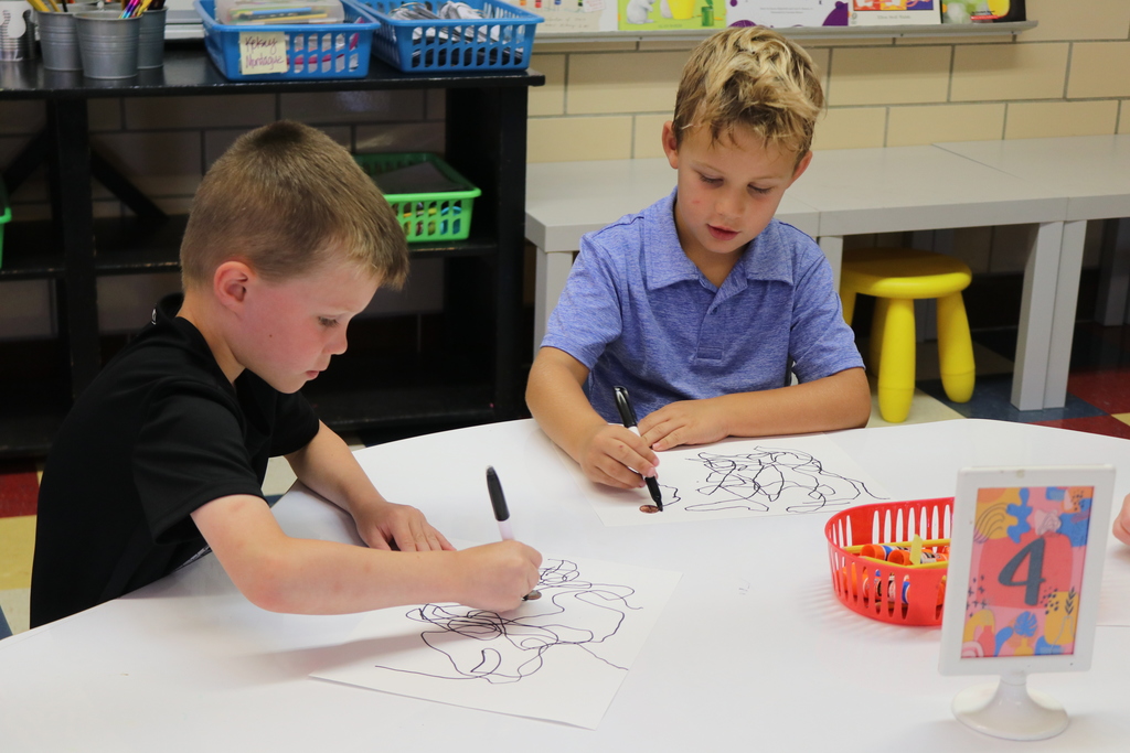 boys in art drawing their wiggle lines