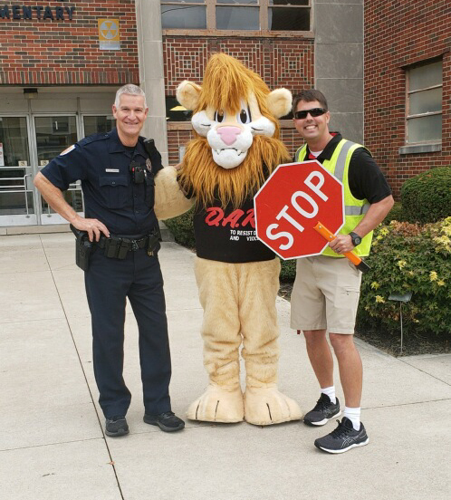 Daren the Lion with Officer Dan and Mr. Petro.